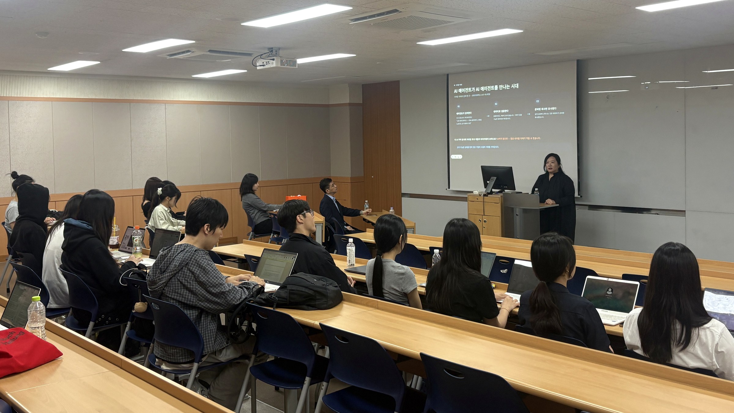 Songyi Yang speaking to rows of Kyung Hee University GTEP students, with the presentation screen visible in the classroom
