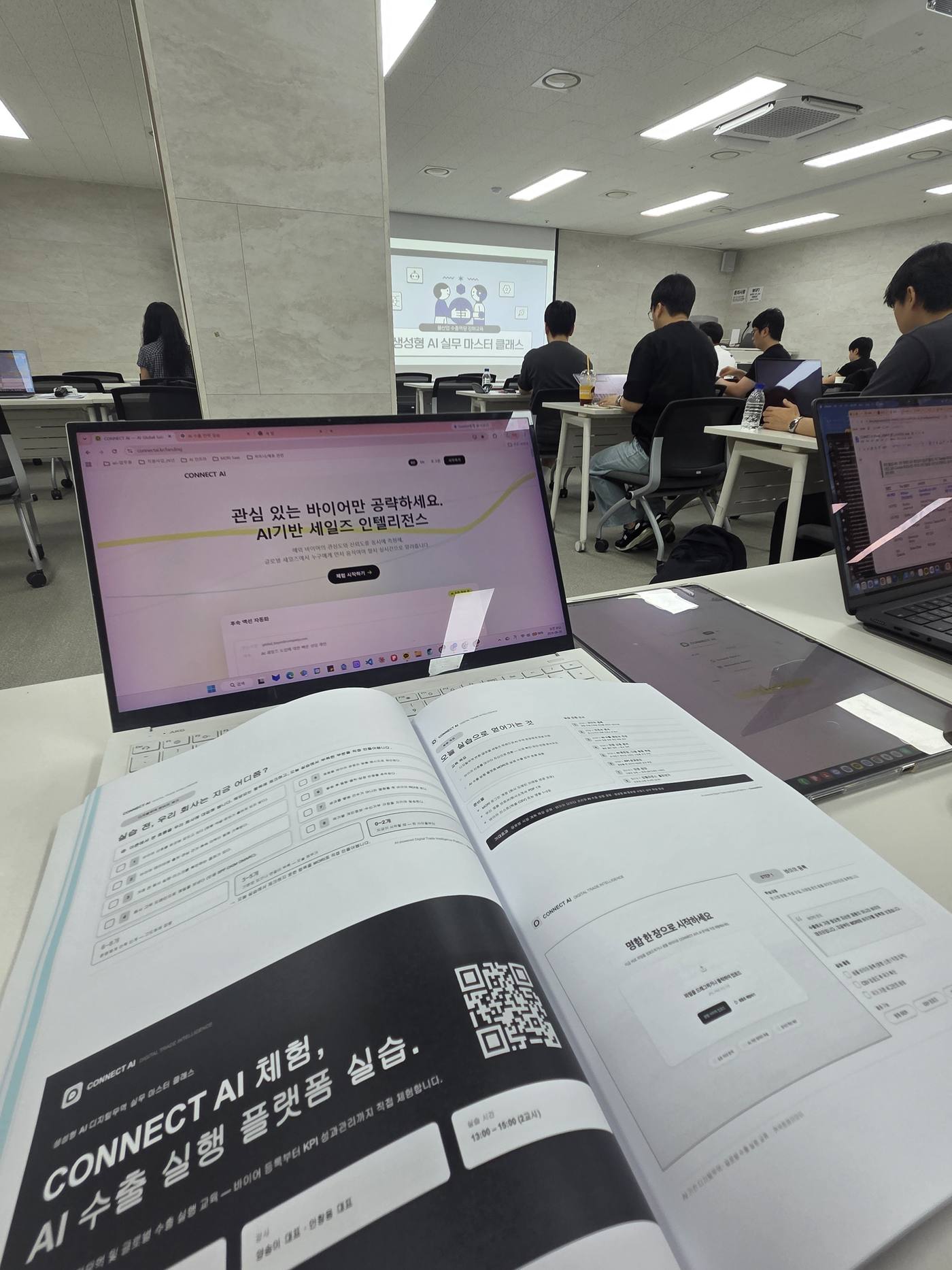 The CONNECT AI hands-on toolkit workbook next to a practice screen
